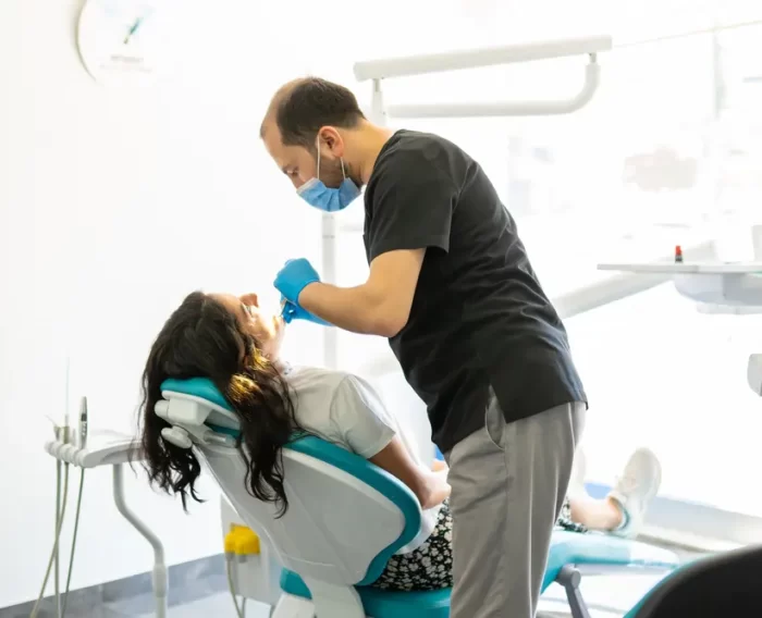 Dentist Muhammed Ali Kurmuş treating a patient