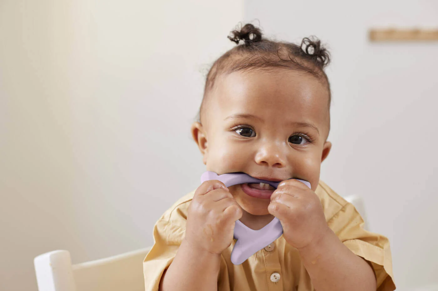 A baby tooth appearing through the gum of a teething baby