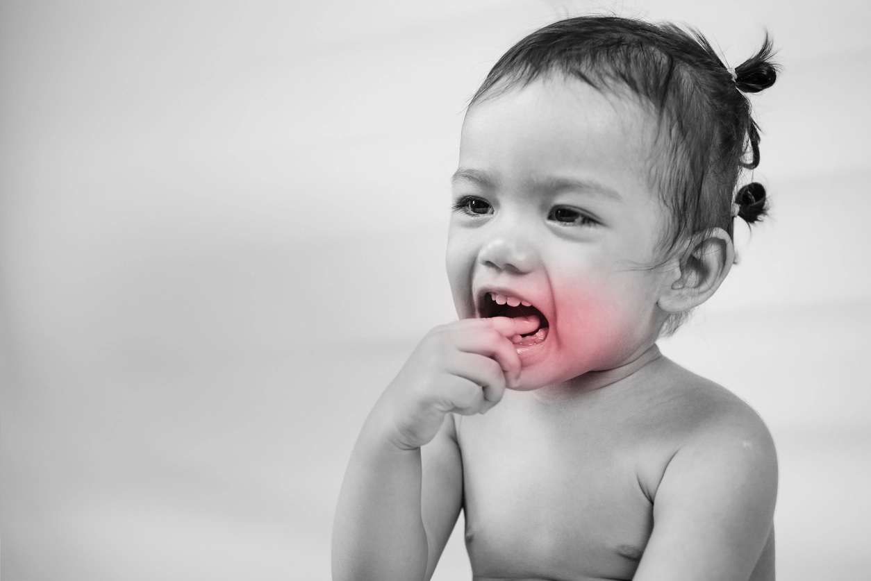 Young child unsettled by pain in the gum area