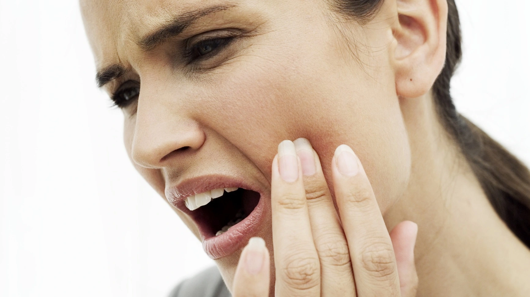 Woman holding her cheek because of toothache